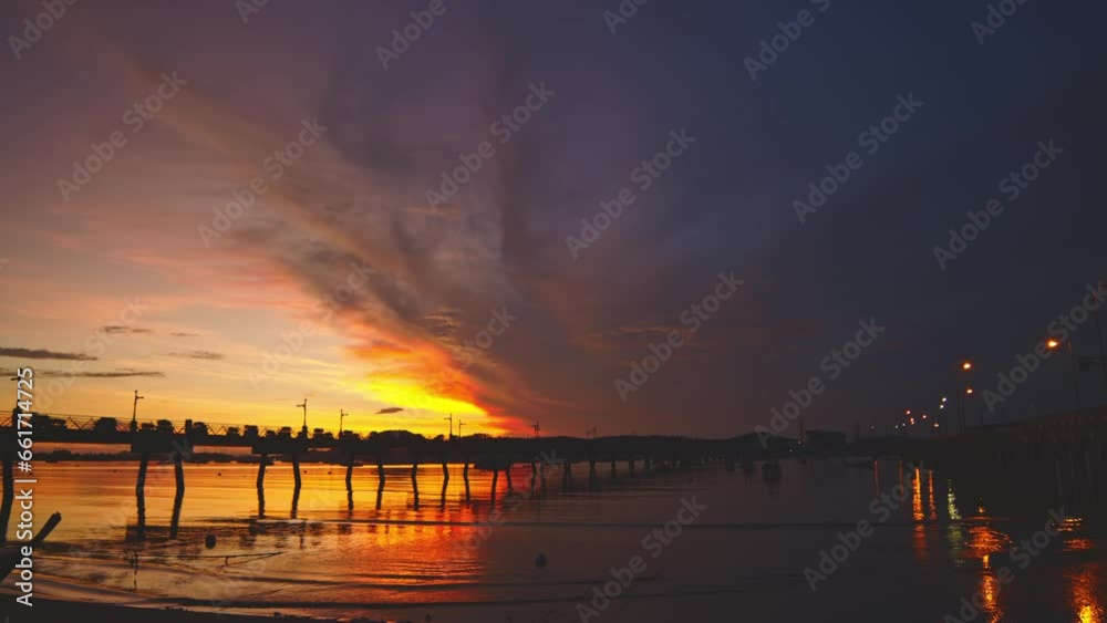 .amazing colorful yellow light through the red cloud in sunrise..Sunrise with sweet yellow color light rays and other atmospheric effects..colorful reflection of sunrise in the sea background.