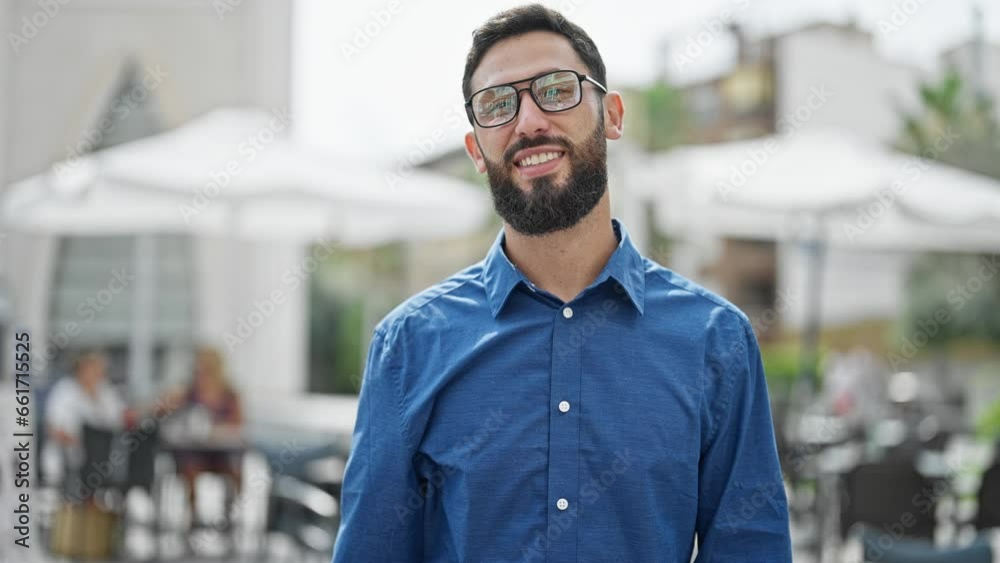 Young hispanic man business worker wearing glasses smiling at coffee shop terrace Young hispanic man business worker wearing glasses smiling at coffee shop terrace