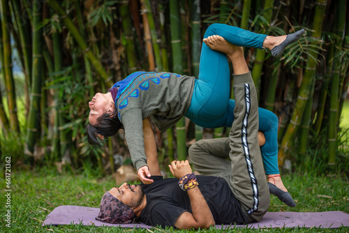 Acroyoga Lunar therapy, Thai massage, couple massage, outdoors, with bamboo background