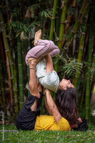 Acroyoga Lunar therapy, Thai massage, couple massage, outdoors, with bamboo background