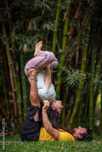 Acroyoga Lunar therapy, Thai massage, couple massage, outdoors, with bamboo background