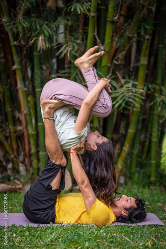 Acroyoga Lunar therapy, Thai massage, couple massage, outdoors, with bamboo background