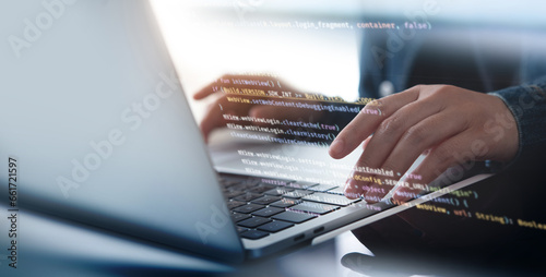 Fototapeta kuchenna Software development concept. Coding programmer, software engineer working on laptop with javascript computer code on virtual screen, internet of things IoT, digital technology
