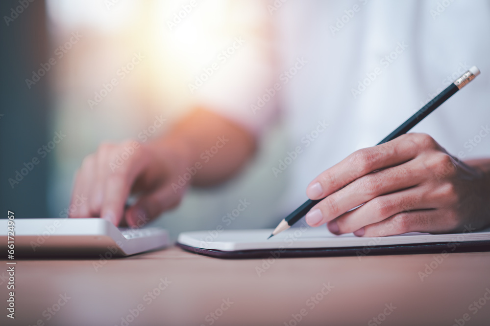 Businessman using a calculator to calculate numbers ,profit and loss statement review of company performance ,cost analysis ,financial paperwork ,Calculation of tax information reports Businessman using a calculator to calculate numbers ,profit and loss statement review of company performance ,cost analysis ,financial paperwork ,Calculation of tax information reports