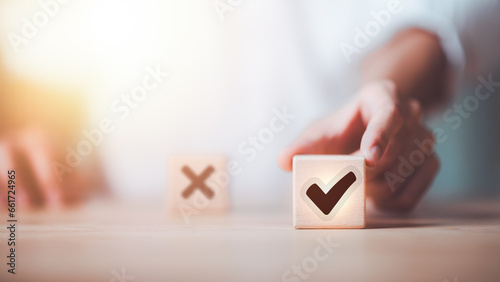 Quadro su tela businessman selects wooden block with check mark icon symbol ,best alternative d