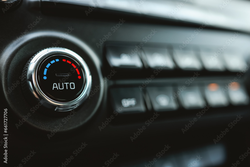 Modern car climate control panel for driver and passenger with shallow depth of field. Zone climate control. Car interior detail