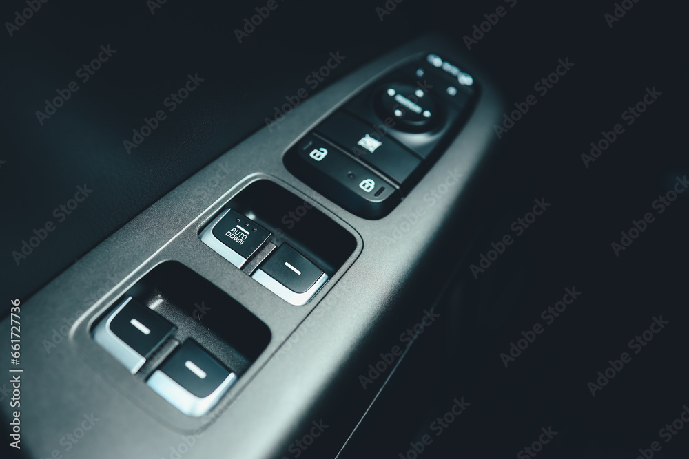 Interior of modern car. Side door buttons: window, mirror adjustment buttons, door lock. Car inside Interior of modern car. Side door buttons: window, mirror adjustment buttons, door lock. Car inside