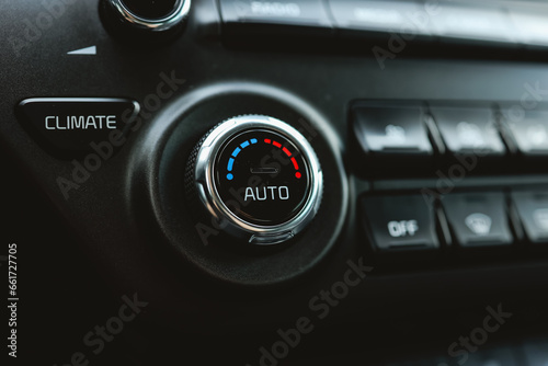 Modern car climate control panel for driver and passenger with shallow depth of field. Zone climate control. Car interior detail
