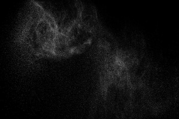 Abstract splashes of water on black background. Freeze motion of white particles. Rain, snow overlay texture.