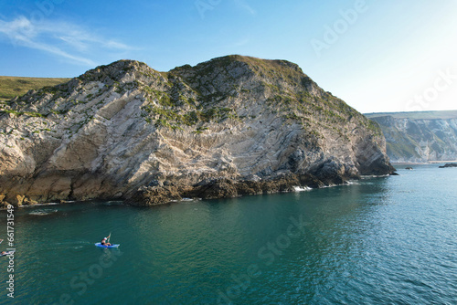 People are Enjoying Boat Ride at Most Beautiful British Landscape and Sea View and Beach of Durdle Door at England Great Britain, UK. Footage Was captured with Drone's camera on September 9th, 2023