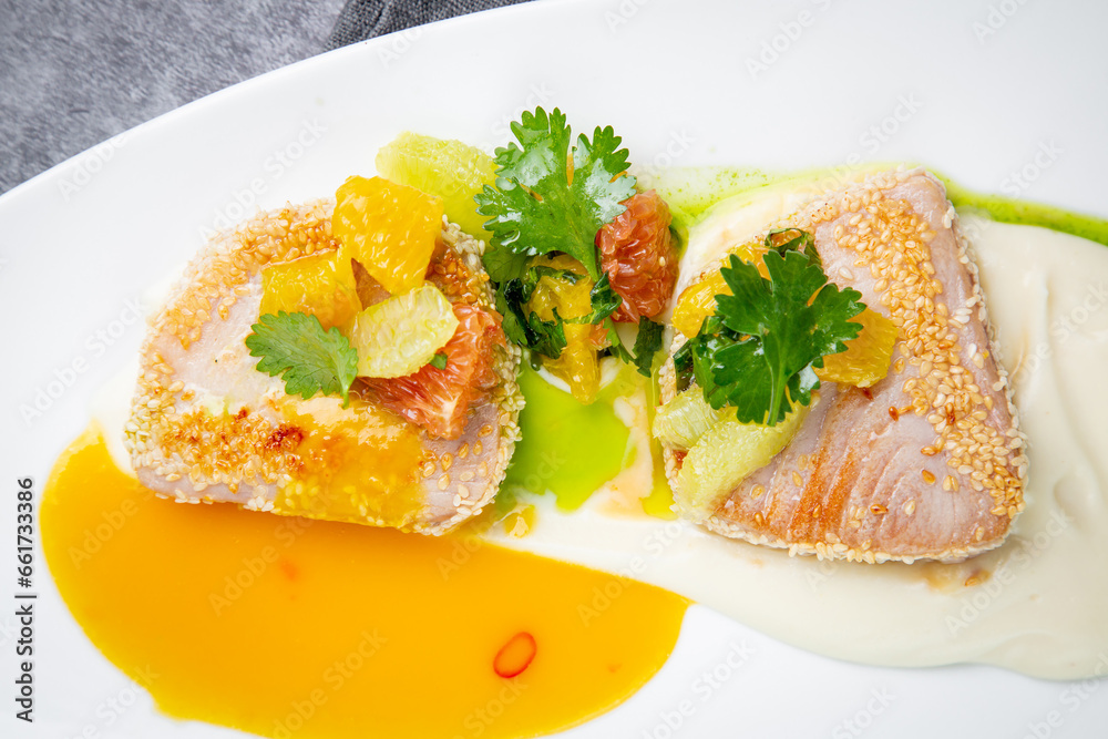 fish with tangerines, parsley and sesame breaded side view fish with tangerines, parsley and sesame breaded side view