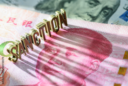Word SANCTION on Chinese yuan note. US has imposed sanctions on China due to trade tensions, human rights concerns, and national security issues, influencing global diplomatic and economic dynamics.