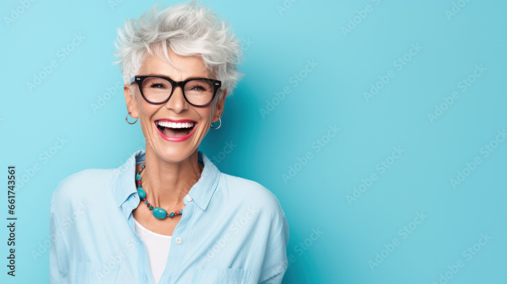 Beautiful and happy blond hair grandma looking at camera isolated on yellow background