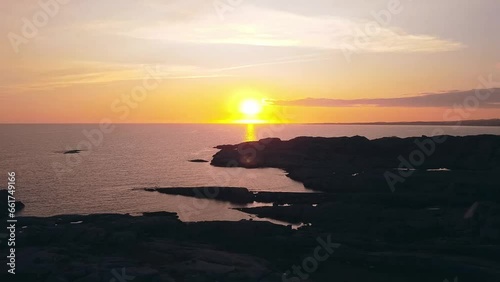 bautyful sunset in Norway over some rocks at the sea, drone, orange, golden hour  photo