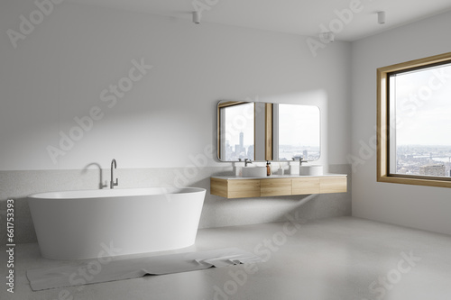 White bathroom corner with tub and double sink