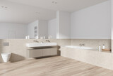 Luxury hotel bathroom interior with toilet, washbasin and tub with accessories