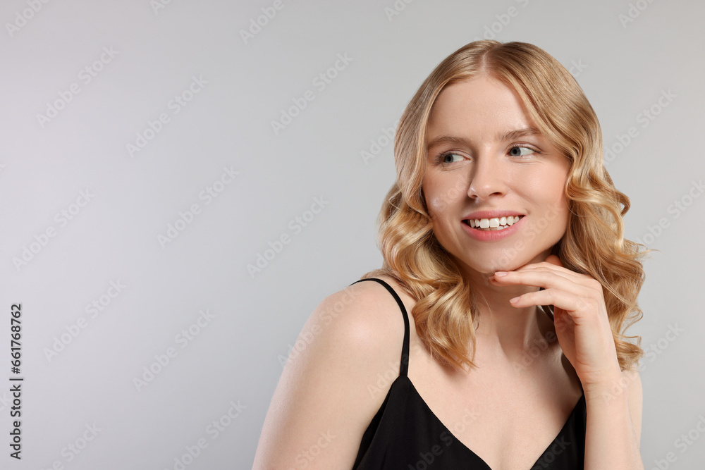 Portrait of beautiful woman with blonde hair on light grey background. Space for text Portrait of beautiful woman with blonde hair on light grey background. Space for text
