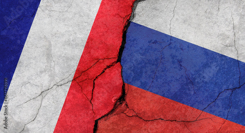 Flags of France and Russia, concrete wall texture with cracks, grunge background, military conflict concept