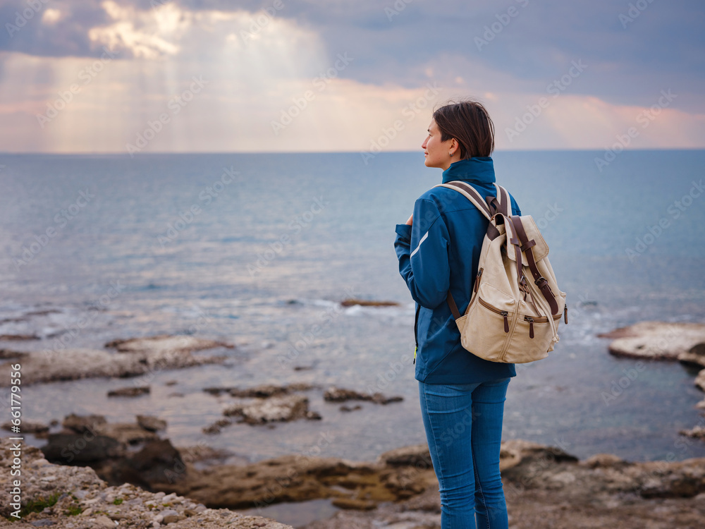 travel to ancient city of Side, Antalya coast of Turkey in tourist low season. woman tourist look on sun over sea