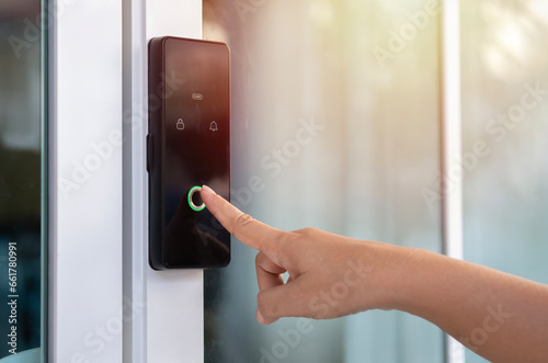 Closeup of a woman's finger entering password code on the smart digital touch screen keypad