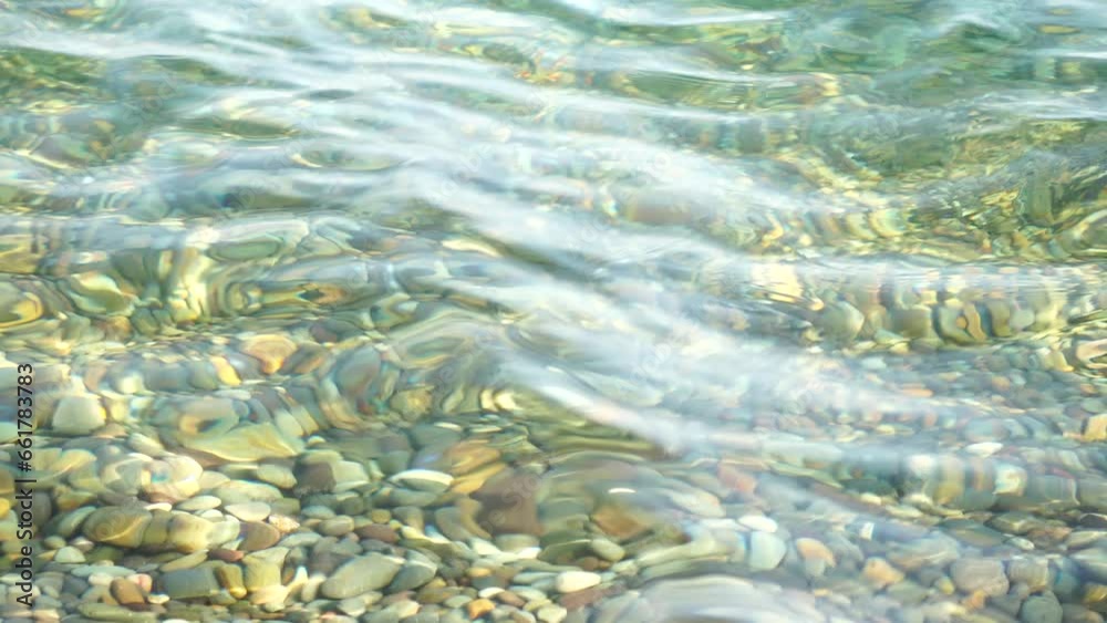 Sea beach pebble. Sea waves with soft, foamy waters washing multicolored pebbles on a beach during sunset. Nobody. Holiday recreation concept. Abstract nautical summer ocean sunset nature Slow motion Sea beach pebble. Sea waves with soft, foamy waters washing multicolored pebbles on a beach during sunset. Nobody. Holiday recreation concept. Abstract nautical summer ocean sunset nature Slow motion