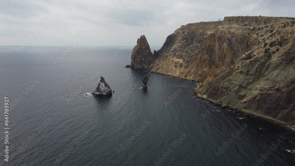 Aerial view on calm azure sea and volcanic rocky shores. Small waves on water surface. Nature summer ocean sea beach view. Nobody. Holiday, vacation and travel concept. Weather and climate change