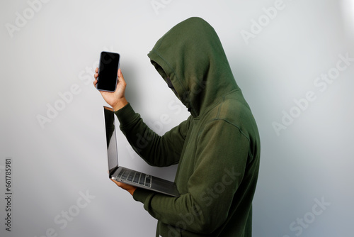 Hacker steal personal data from the mobile phone and laptop isolated on white background. photo