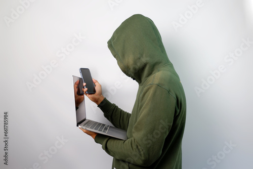 Hacker steal personal data from the mobile phone and laptop isolated on white background. photo