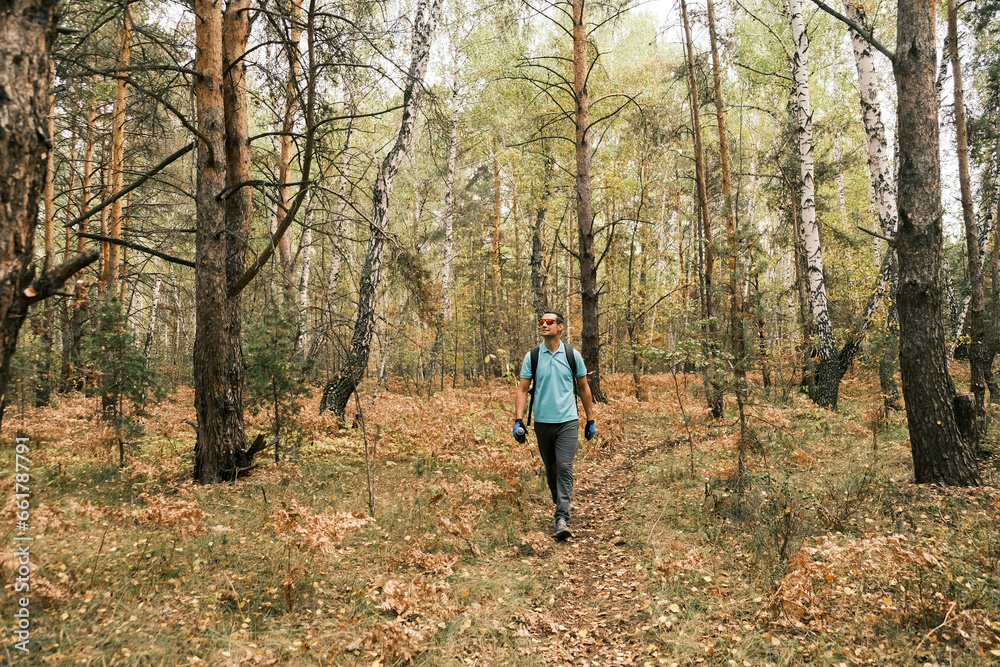  active lifestyle.A man with a backpack walks through the autumn forest.Healthy lifestyle