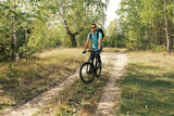 active lifestyle.A man with a backpack rides a mountain bike through the autumn forest.Mountain Bike