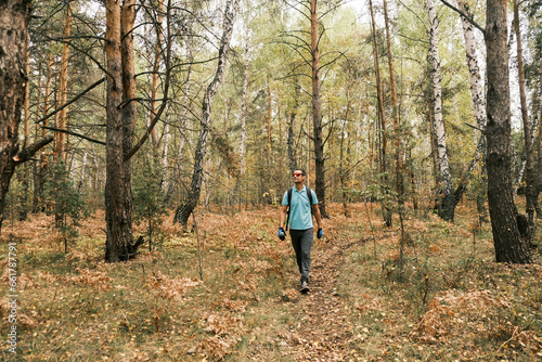  active lifestyle.A man with a backpack walks through the autumn forest.Healthy lifestyle © anwel