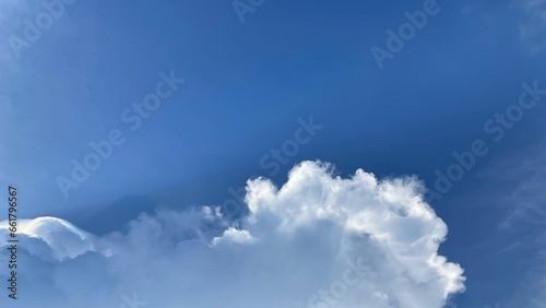 Image of a blue sky and some clouds with copy space for text.  photo