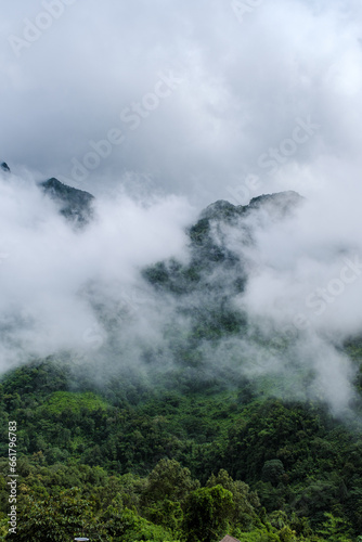 Mountain peak of Doi Luang Chiang Dao mountain hills in Chiang Mai, Thailand. Nature landscape in travel trips and vacations. Doi Lhung Chiang Dao Viewpoint with mist and fog during rain season