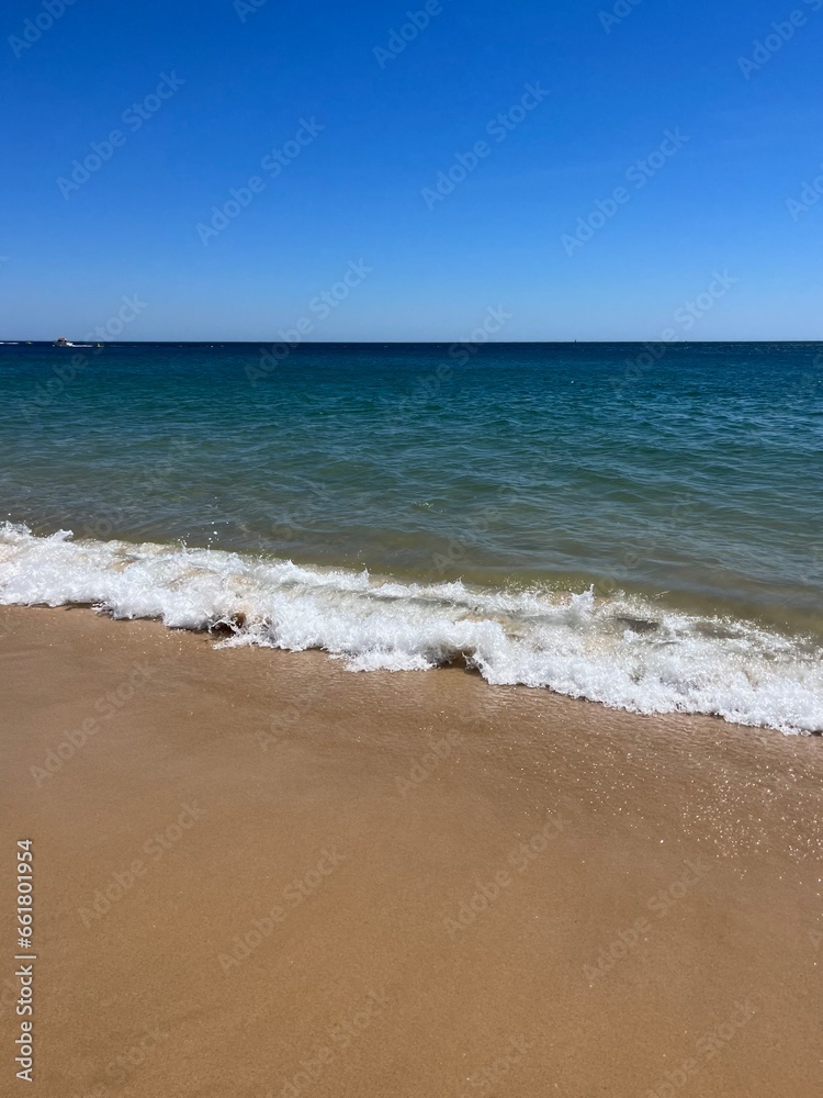 Blue sea horizon, clear sky, sandy coast