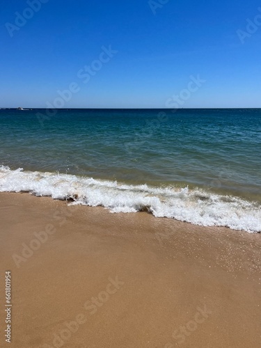 Blue sea horizon, clear sky, sandy coast