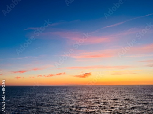 Beautiful purple ocean view, sky after the sunset, pink clouds, sea horizon, ocean coast 