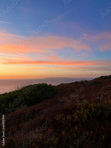 Beautiful purple ocean view, sky after the sunset, pink clouds, sea horizon, ocean coast 