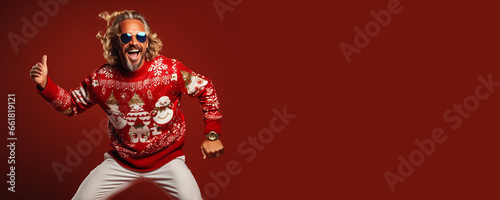 Ugly Christmas Sweater Day. Cool old man dancing in knitted clothes, red background. Banner, copy space