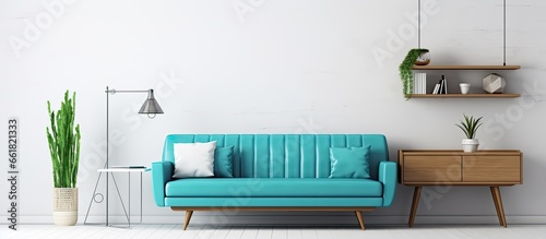 Modern apartment with turquoise couch in open living room and workspace by white wall With copyspace for text