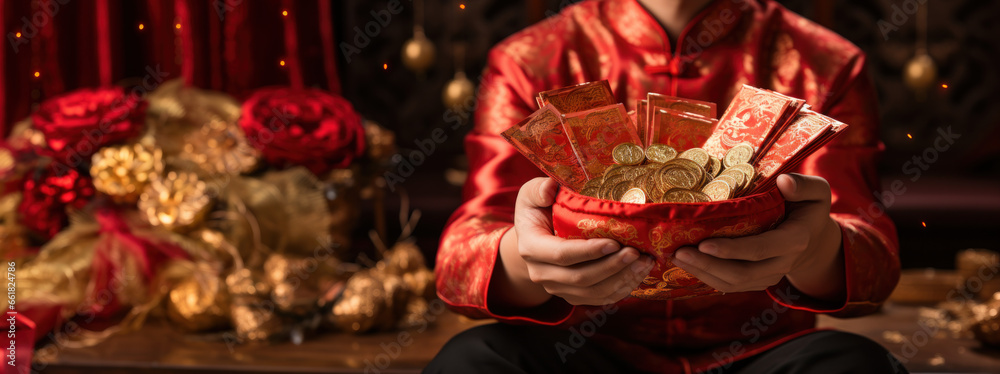 Naklejka premium Happy Chinese New Year, A Chinese man exuberantly holding a collection of red packets filled with gold and coins, celebrating the joyous occasion of the Lunar New Year