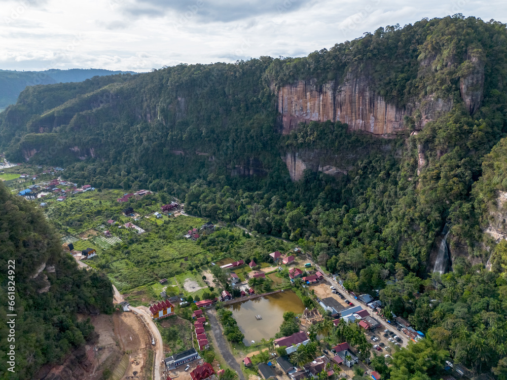 Obraz premium Aerial view of Harau Valley, a popular tourist spot featuring mountains and rice fields at Sumatra island, Indonesia.