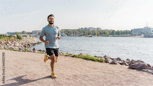Athlete trainer exercises to warm up the body.  Mental and psychological health. Hobby jogging in running shoes. A healthy man who trains actively interval training.