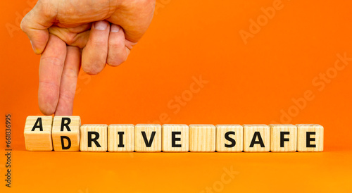 Drive and arrive safe symbol. Concept words Drive safe Arrive safe on wooden blocks. Beautiful orange table orange background. Businessman hand. Business drive and arrive safe concept. Copy space.