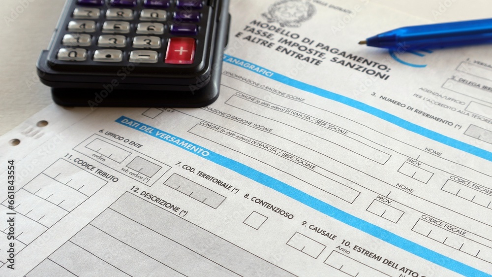 Form For Italian Taxes Editorial - Calculator and ballpoint pen on the table. Form For Italian Taxes Editorial - Calculator and ballpoint pen on the table.