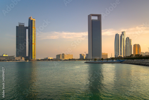 Skyscrapers on the shore of the bay, view of Abu Dhabi at sunset