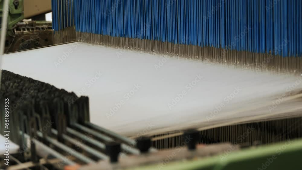 weaving loom. Close-up. industrial weaving loom machine in working process, at a textile factory. Weaving. weaving loom. Close-up. industrial weaving loom machine in working process, at a textile factory. Weaving.