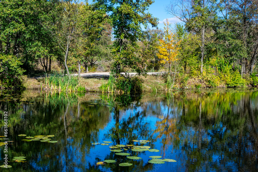 Beginning of autumn. October. By a small river.