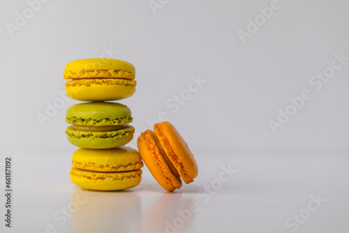 French macarons or Assorted colorful macaroons, with copy space. Colorful holiday treats, almond cookies. Sweet meringue-based confection made with egg white, icing sugar, granulated sugar, almond