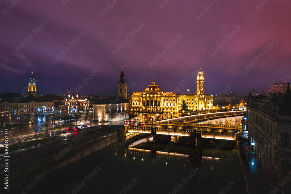 Oradea romania tourism aerial a city's nighttime charm captured from a bridge, showcasing its historic and cultural attractions in Europe