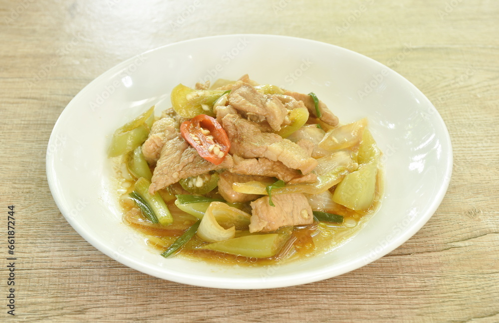 fried slice pork meat with onion and long chili on plate fried slice pork meat with onion and long chili on plate